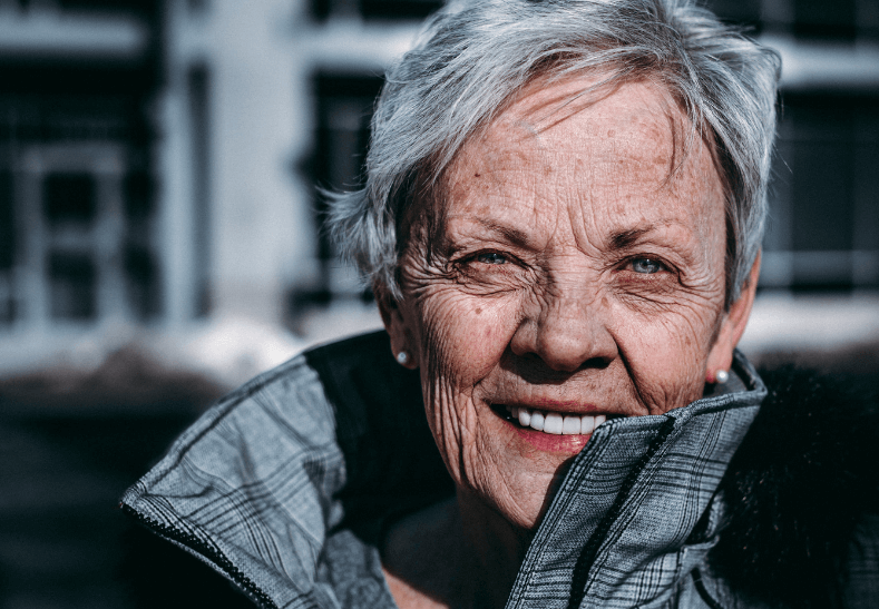 Old woman with dental implants in London