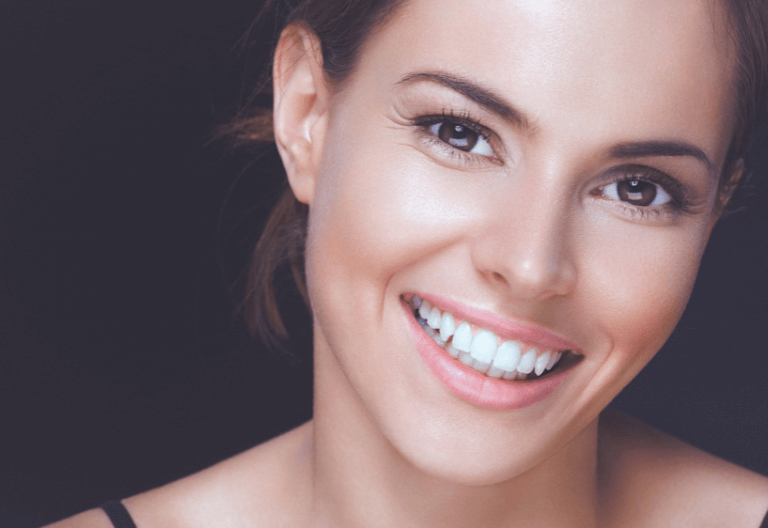 Woman with dental implants and good dental health in London