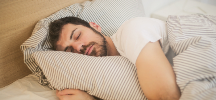 man wearing Invisalign aligners while sleeping with sleep apnea