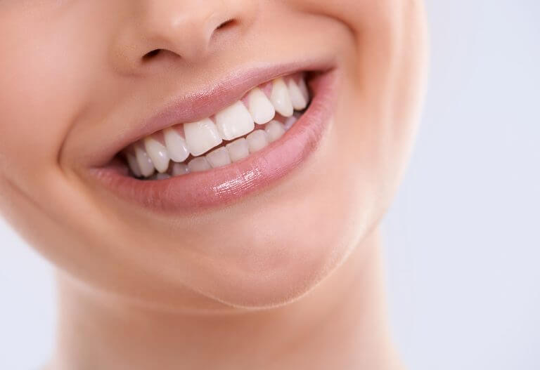 Smiling with white teeth showing.