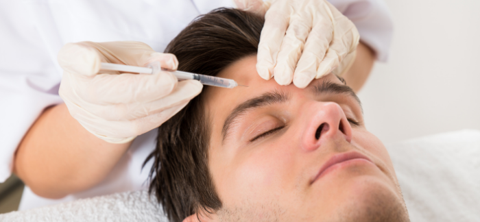 Man getting Botox treatment in his forehead