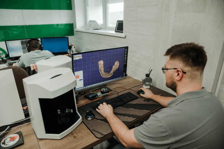 dentist working on designing dental implant in London