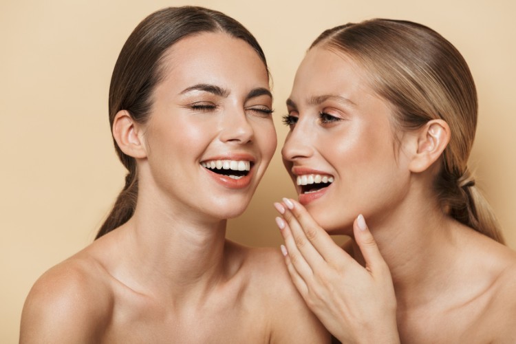 two women smiling at each other with fillings