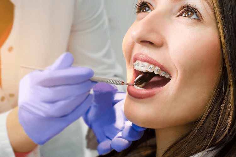 woman with braces receiving a dental consultation. Can Braces Fix My Bite?