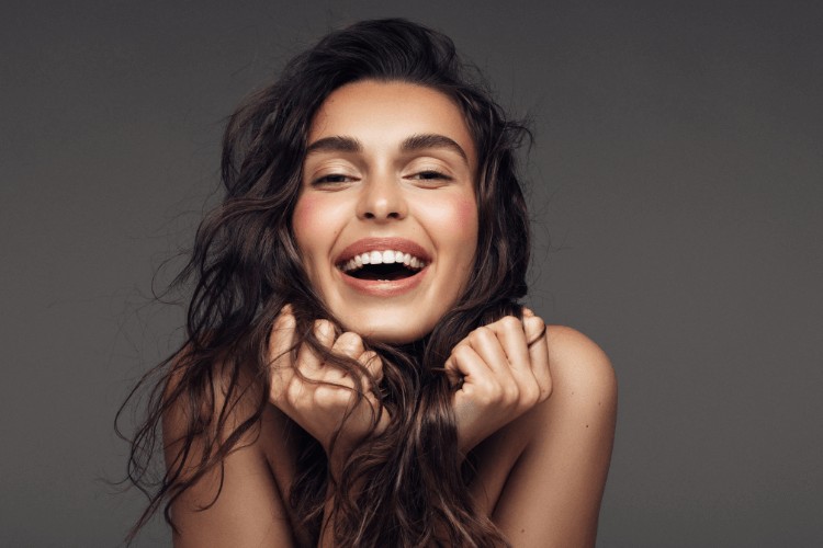 woman with white teeth smiling after receiving teeth whitening in Clapham