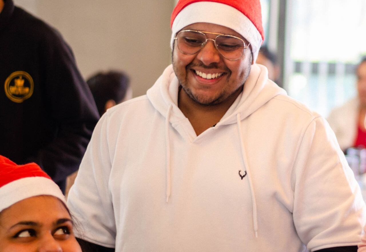 Man in dentist wearing Christmas hat
