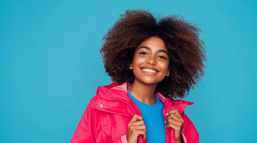 girl smiling at the camera with white fillings that have been whitened teeth.